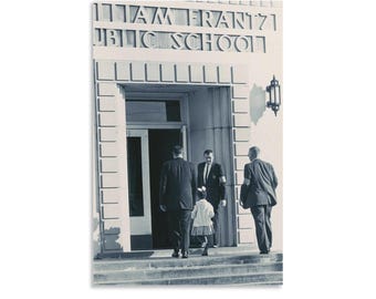 May include: Black and white photograph of a school building entrance with the text "WILLIAM FRANTZ PUBLIC SCHOOL" above the door. Several people in suits and a young girl are entering the building.