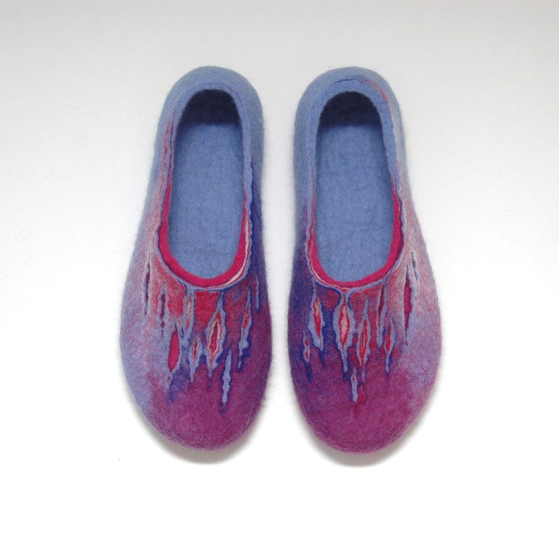 May include: A pair of blue and purple wool slippers with a red and pink design. The slippers are made of felted wool and have a soft, comfortable feel.