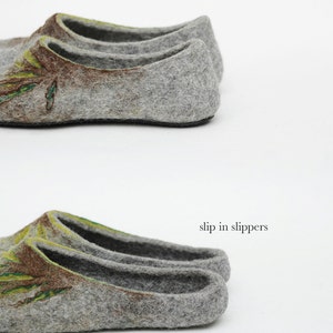 May include: Two pairs of gray felt slippers with a green and brown floral design. The top pair has a full back, while the bottom pair is a slip-on style.