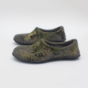May include: A pair of gray and green wool slippers with a camouflage pattern.
