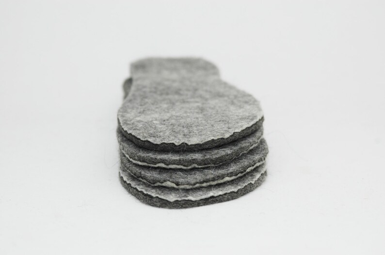 May include: A stack of five grey felt circles, each with a slightly irregular shape.