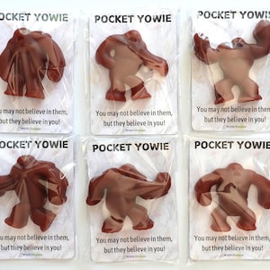 May include: Six brown plastic toy figures of a monster with the text "Pocket Yowie" and "You may not believe in them, but they believe in you!" on each card.