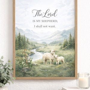 May include: Framed artwork featuring a pastoral scene with a mother sheep and lamb near a stream, with mountains in the background. The text "The Lord is my shepherd; I shall not want. Psalm 23:1" is displayed in elegant script.
