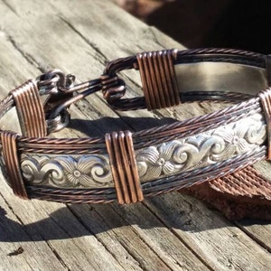 Texan: Sterling silver and Copper bracelet; antiqued.