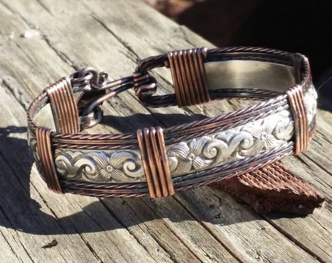 Texan: Sterling silver and Copper bracelet; antiqued.