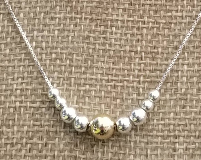 Simple and Pretty: A Sterling Silver chain and beads with a 14kt Gold filled focal bead.