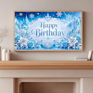 May include: A framed wall art piece with a winter theme. The artwork features a blue and white design with the words "Happy Birthday" in elegant script. Snowflakes, roses, and a castle are also depicted.