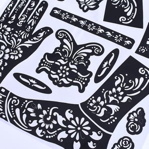 May include: Black henna tattoo stencils with intricate floral and paisley designs. The stencils include hand, wrist, and other decorative patterns. The designs are on a white background.