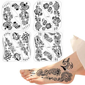 May include: Black henna tattoo stencils with floral and paisley designs. The stencils are in various shapes and sizes, with the numbers J401, J402, J403, and J404 printed on them. A foot is shown with a henna tattoo.