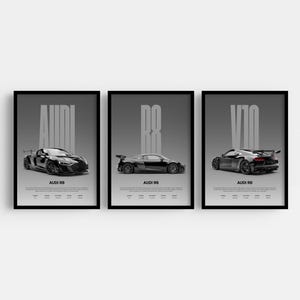 May include: Three framed prints featuring black Audi R8 sports cars. Each print has a gray background with the word "AUDI" or "R8" or "V10" in large white letters. The prints also include the text "AUDI R8" at the bottom.