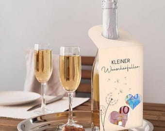 May include: A champagne bottle with a decorative tag featuring the text "Kleiner Wunscherfüller" and heart-shaped illustrations. Two champagne flutes and a cork sit on a silver tray, suggesting a celebratory theme.