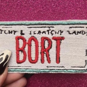 May include: A set of three ceramic mugs with a speckled, matte finish. The mugs are in shades of cream, light gray, and dark gray. Each mug has a simple, minimalist design, perfect for coffee or tea.