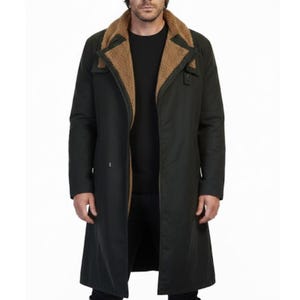 May include: A dark green long coat with a brown faux fur collar. The coat has a classic design with a button closure and a long length. The coat is made of a durable material and is suitable for cold weather.