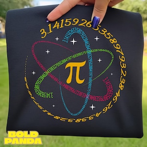 May include: Black t-shirt featuring a colorful design with the mathematical symbol pi and the digits of pi arranged in a circular pattern. The text "BOLD PANDA" is at the bottom.