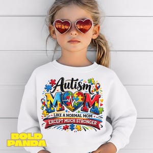 May include: White sweatshirt with the text "Autism Mom" in colorful puzzle piece letters and a heart. The sweatshirt also includes the text "Like a normal mom except much stronger". The child is wearing heart-shaped sunglasses.