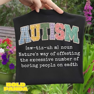 May include: Black t-shirt featuring the word "AUTISM" in a patchwork design with various colours. The text below defines autism as "Nature's way of offesting the excessive number of boring peoplz on eadth."