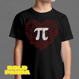 May include: Black t-shirt featuring a heart-shaped design filled with mathematical symbols and equations. The heart contains a floral-decorated Pi symbol. The shirt is a fun and educational design for math enthusiasts.