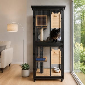 May include: A black cat is inside a black metal cat cage with wire mesh sides. The cage has wooden shelves, a scratching post, and two small wooden doors shaped like cat ears. Two white cat bowls are at the bottom.