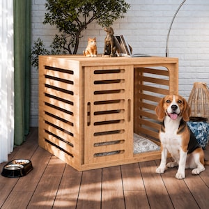 May include: A light-colored wooden dog crate with horizontal slats and a sliding door, featuring a patterned cushion inside. A beagle sits in front of the crate, and a black double pet bowl is placed on the floor to the left of the structure.