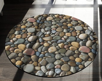 May include: A round rug with a pebble design. The rug is made of a soft, durable material and features a variety of colors, including brown, gray, and beige.