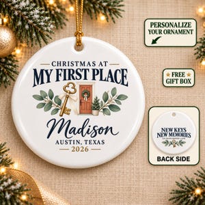 May include: A round white ceramic ornament featuring the text "CHRISTMAS AT MY FIRST PLACE", "Madison", "AUSTIN, TEXAS", and "2026". The design includes a gold key with a white ribbon, a red door with a wreath, and green foliage. The back shows "NEW KEYS NEW MEMORIES".