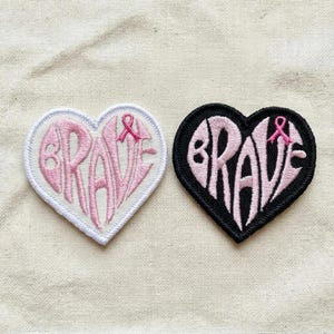 May include: A white ceramic mug with a black handle and the text "But First, Coffee" in a bold, black font. The mug is set against a blurred background, highlighting its simple design.