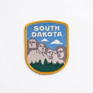 May include: A rustic wooden sign with the text "Welcome to our home" in white lettering. The sign features a distressed finish and a simple, inviting design, perfect for front door decor.