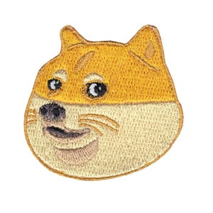 May include: Embroidered patch featuring the Doge meme. The patch depicts the Shiba Inu dog's face with a yellow and beige color scheme. The dog has black eyes and a black nose, with a smiling expression.