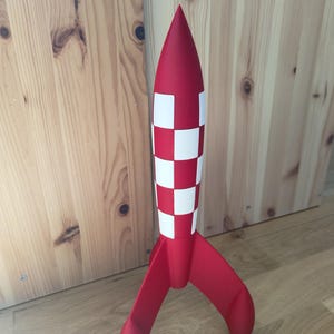 May include: A distressed wooden sign displaying the words "Welcome to our home" in white. The sign has a rustic appearance, ideal for adding a welcoming touch to any home's entrance.