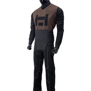May include: A costume set featuring a brown V-neck vest with a black rectangular emblem, worn over a black long-sleeve shirt with white geometric stitching. The outfit includes a black waist belt and matching black trousers with white line details.