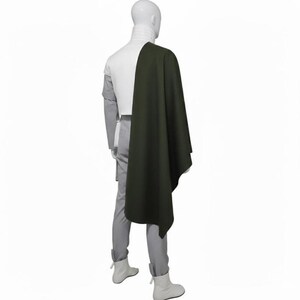 May include: A white ceramic mug with a black handle and the text "But First, Coffee" in a bold, black font. The mug is set against a blurred background, suggesting a cozy setting.