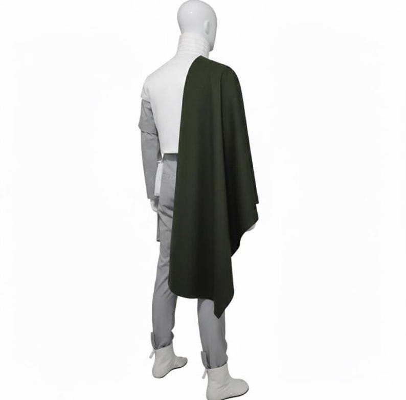 May include: A white ceramic mug with a black handle and the text "But First, Coffee" in a bold, black font. The mug is set against a blurred background, suggesting a cozy setting.