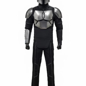 May include: A full-body costume featuring a silver helmet and chest armor. The costume includes black pants and a long-sleeved shirt with silver accents. The armor has a metallic finish, and the outfit is designed to resemble a character from a science fiction series.