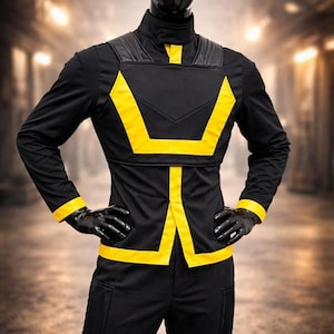 May include: Black jumpsuit with yellow accents, displayed on a mannequin. The outfit features a high collar, a yellow geometric design across the chest and torso, and yellow trim on the sleeves. The mannequin wears black gloves.