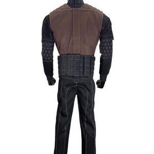 May include: A full-body costume set featuring a black long-sleeved shirt with white geometric grid patterns on the sleeves, a brown vest with quilted shoulder detailing, a black tactical-style waist belt, and matching black trousers with white stitching.