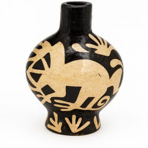May include: A black and tan ceramic vase with a rounded body and a narrow neck. The vase features a tan animal design and hand-like shapes against a black background. The vase is likely handmade and suitable for home decor.