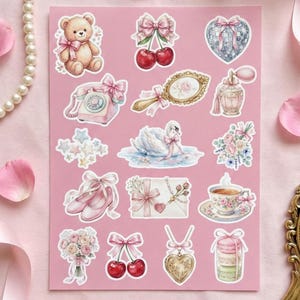 May include: A sheet of pink stickers featuring various illustrations, including a teddy bear, cherries, a heart, a telephone, a mirror, a swan, ballet shoes, a bouquet, a teacup, a locket, and macarons. The stickers have a vintage, romantic aesthetic.