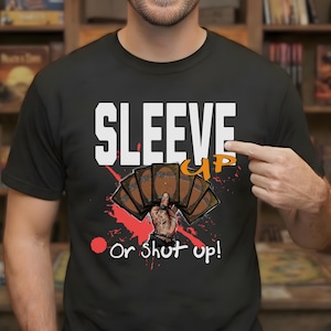 May include: Black t-shirt with the text "SLEEVE UP" in white block letters and "Or shut up!" below. The shirt features a graphic of a hand holding playing cards, with red splatter accents.