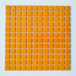 Peut inclure: Une grille carrée composée de petits carreaux de céramique jaune moutarde brillants, disposés selon un motif uniforme. Chaque carreau individuel est un carré parfait aux bords arrondis, créant une texture répétitive et cohérente.