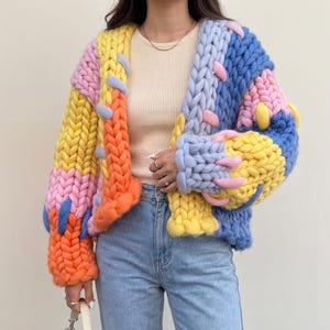 May include: A set of three ceramic mugs with a speckled, matte finish in cream, light grey, and dark grey. Each mug has a simple, minimalist design, suitable for coffee or tea.