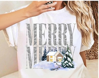 May include: A white short-sleeved t-shirt featuring the text MERRY MERRY in a black and white zebra print pattern. Below the text is a graphic illustration of a house with snow-covered roofs and pine trees in a winter landscape.