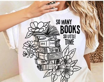 May include: A white t-shirt featuring a black line art graphic of a stack of books topped with an open book and surrounded by flowers. The text "SO MANY BOOKS SO LITTLE TIME" is printed in black capital letters to the right of the book stack.