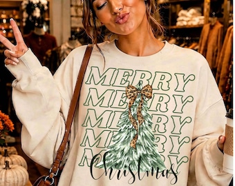 May include: A cream-colored crewneck sweatshirt featuring the repeated green text MERRY in a wavy font. A central illustration of a green pine tree is topped with a leopard print bow, and the word Christmas is written in a dark green script below.