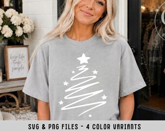 May include: A light gray short-sleeved t-shirt featuring a white graphic of a stylized, hand-drawn Christmas tree made of a single continuous wavy line, accented with several small white stars. The text SVG & PNG FILES - 4 COLOR VARIANTS is visible.