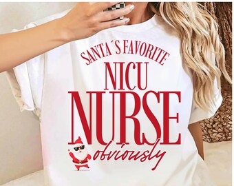 May include: A white short-sleeved t-shirt featuring red text that reads SANTA'S FAVORITE NICU NURSE obviously. Below the text is a small graphic of Santa Claus wearing black sunglasses and waving with one hand.