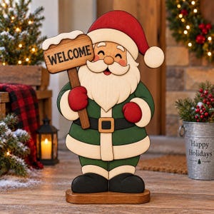 May include: A wooden Santa Claus figure wearing a red hat, green coat, and black boots, holding a brown sign with the word WELCOME printed in black. The figure features a white beard, red mittens, and a tan belt with a square buckle.