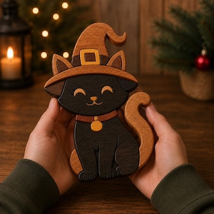 May include: A wooden cat figurine featuring a black body, a light brown witch hat with a square buckle, and a light brown tail. The cat has closed eyes, a small nose, and a collar with a round tag. The piece is crafted from layered wood.