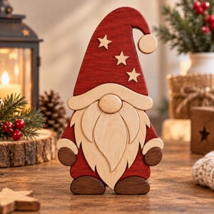 May include: A wooden gnome figurine featuring a tall red hat adorned with three light-colored wooden stars and a round pom-pom. The gnome has a light-colored wooden beard, a round nose, dark brown mittens, and dark brown shoes.