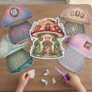 Child's hands using purple scissors to cut out a DIY printable fairy cottage paper craft set. The flat lay includes a large mushroom-shaped fairy house sticker and several decorative mushroom rooms with pastel floral patterns, vine wallpaper, and tiny framed art. This magical cottagecore activity is perfect for kids' scrapbooking, imaginative play, and creative forest-themed paper doll projects.