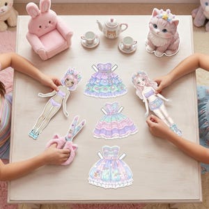 Soft Pastel Kawaii paper doll kit on a white table. Includes 4 colorful outfits, 120+ doll options, and cute accessories. Aesthetic washi tape and a pastel pen nearby. Pre-fitted clothing for easy print-and-cut play, perfect for anime fans and aesthetic Pinterest-style crafting.